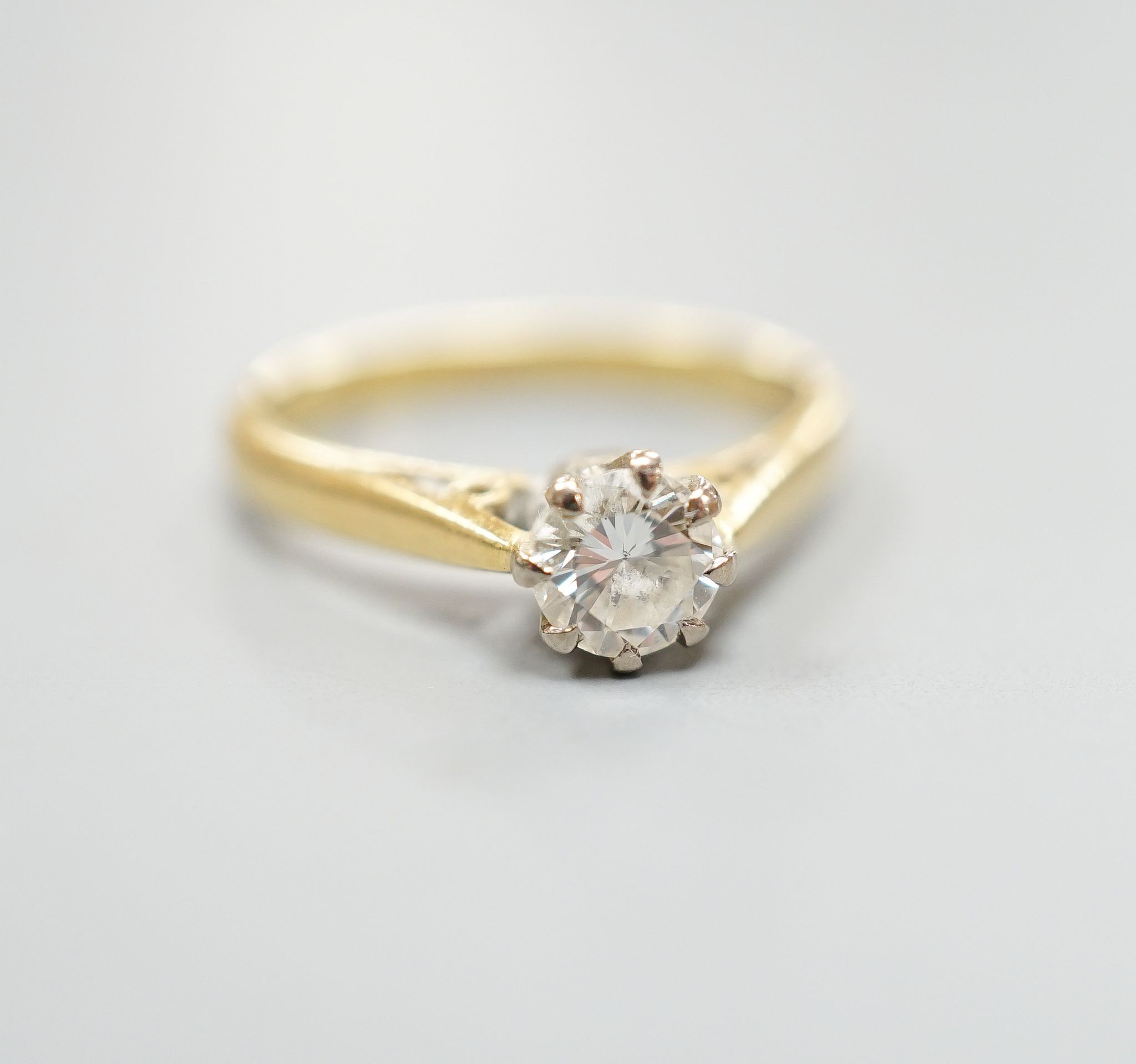 A modern 18ct gold and solitaire diamond ring, size N, gross weight 3.5 grams